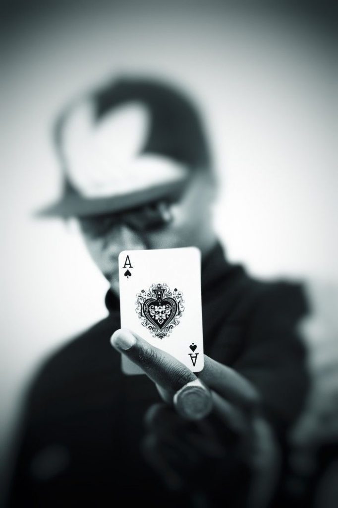 gambler holding poker card