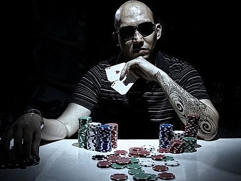 man with poker face in dark room